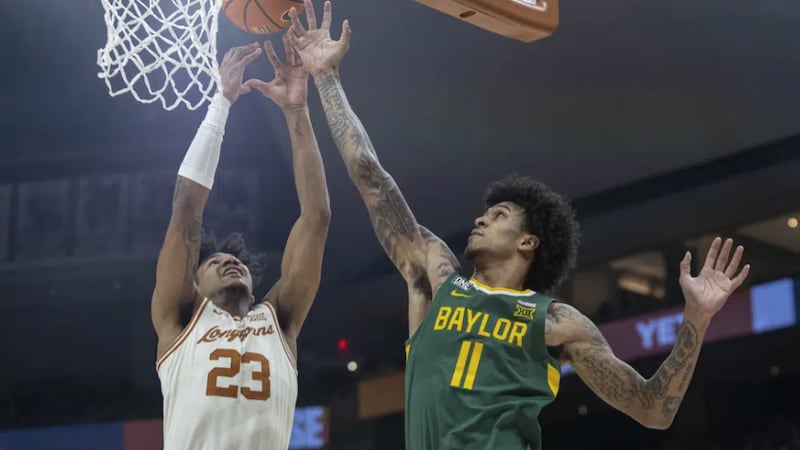 Texas forward Dillon Mitchell (23) and Baylor forward Jalen Bridges (11) reach for a rebound...