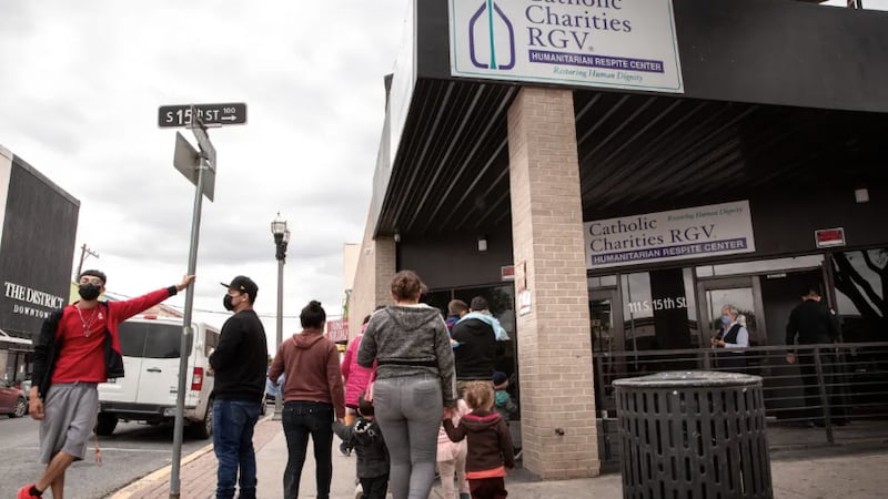 Migrants are greeted by Sister Norma Pimentel in front of the Catholic Charities RGV...