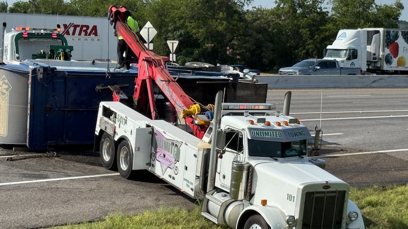 Waste Connection trash truck on its side on I-35N between the I-14 overpass and Central Ave....