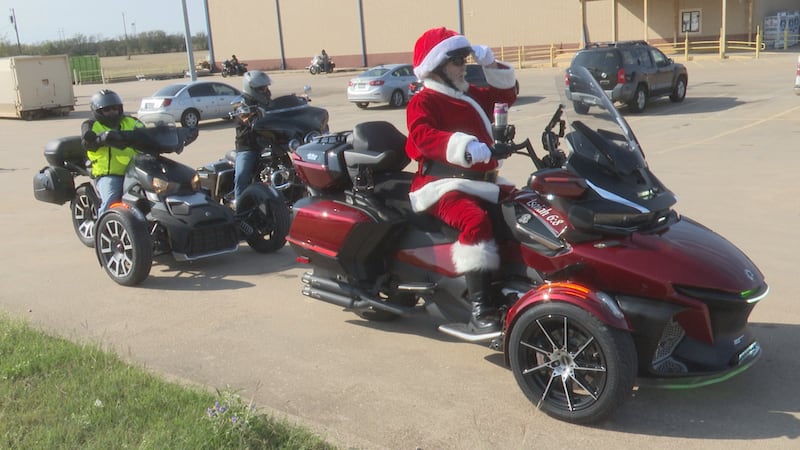 Motorcyclist dressed as Santa Claus delivers toys to a Bosque County charity for children in need