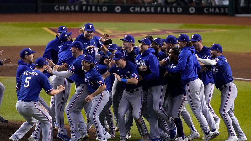 Texas Rangers celebrate after winning Game 5 of the baseball World Series against the Arizona...