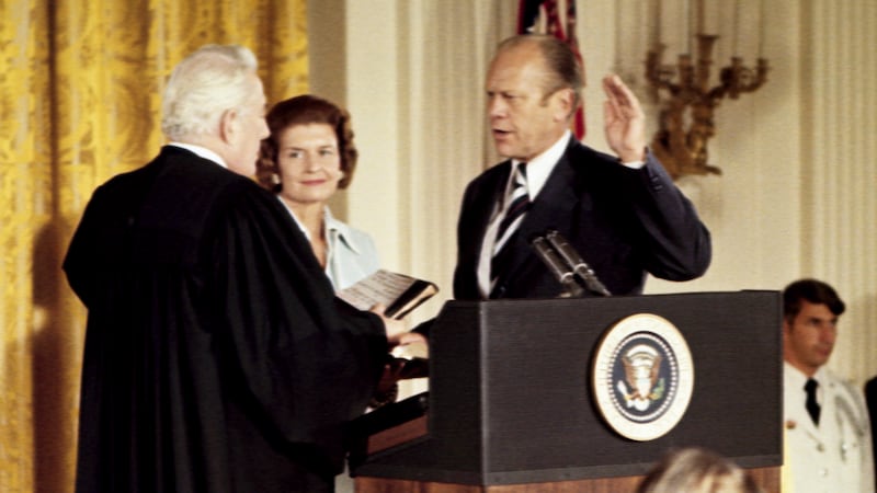 Gerald Ford, right, takes the oath of the office of the Presidency, from Chief Justice Warren...